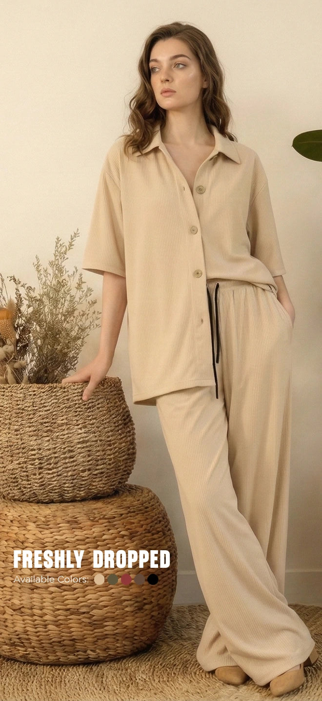 Woman wearing beige co-ord set with button-down shirt and wide-leg pants, neutral background.